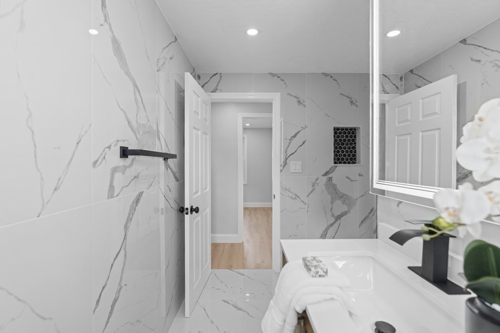 181 Green Street Stoneham, MA 02180 - Photo 24 of 42 a bathroom with a bathtub and a shower