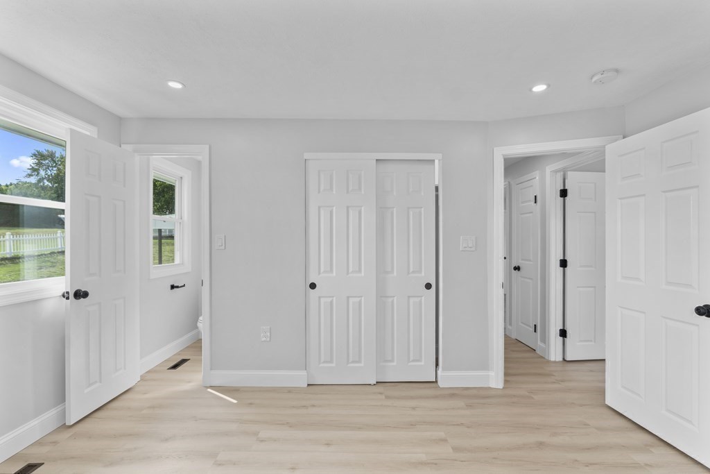 181 Green Street Stoneham, MA 02180 - Photo 25 of 42 a view of a livingroom with wooden floor and white walls