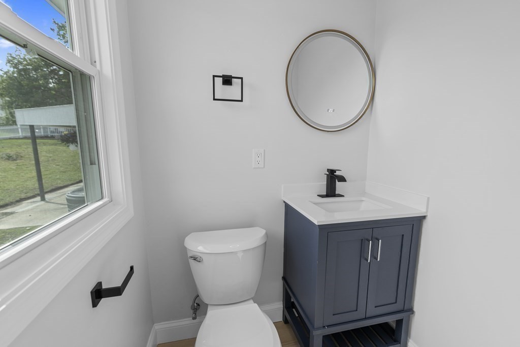 181 Green Street Stoneham, MA 02180 - Photo 27 of 42 a bathroom with a toilet a sink and a mirror