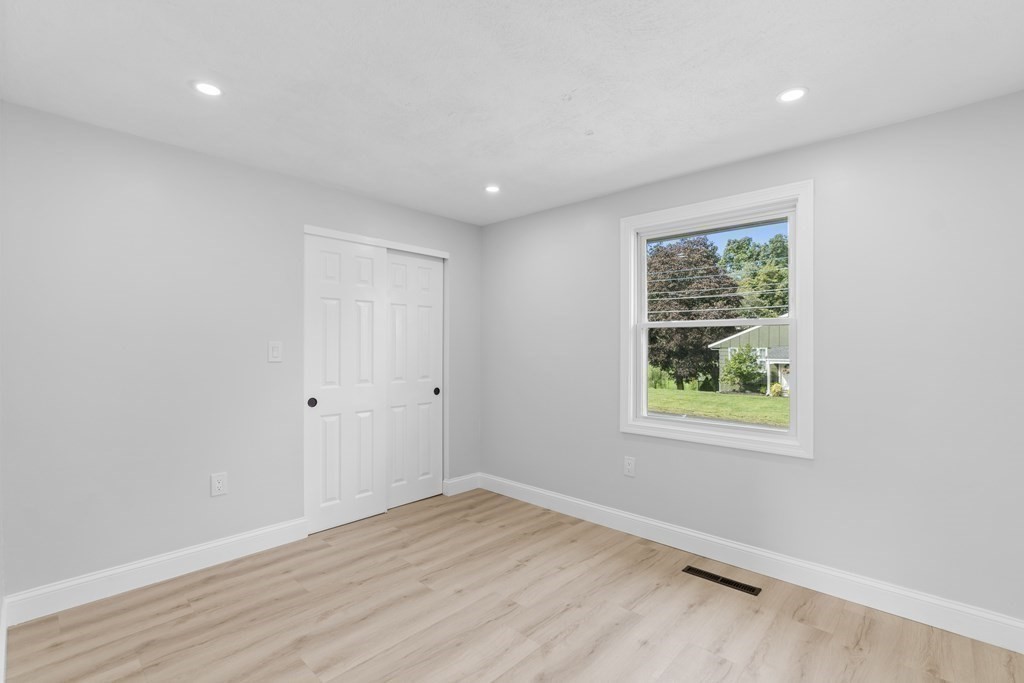 181 Green Street Stoneham, MA 02180 - Photo 28 of 42 an empty room with wooden floor and window