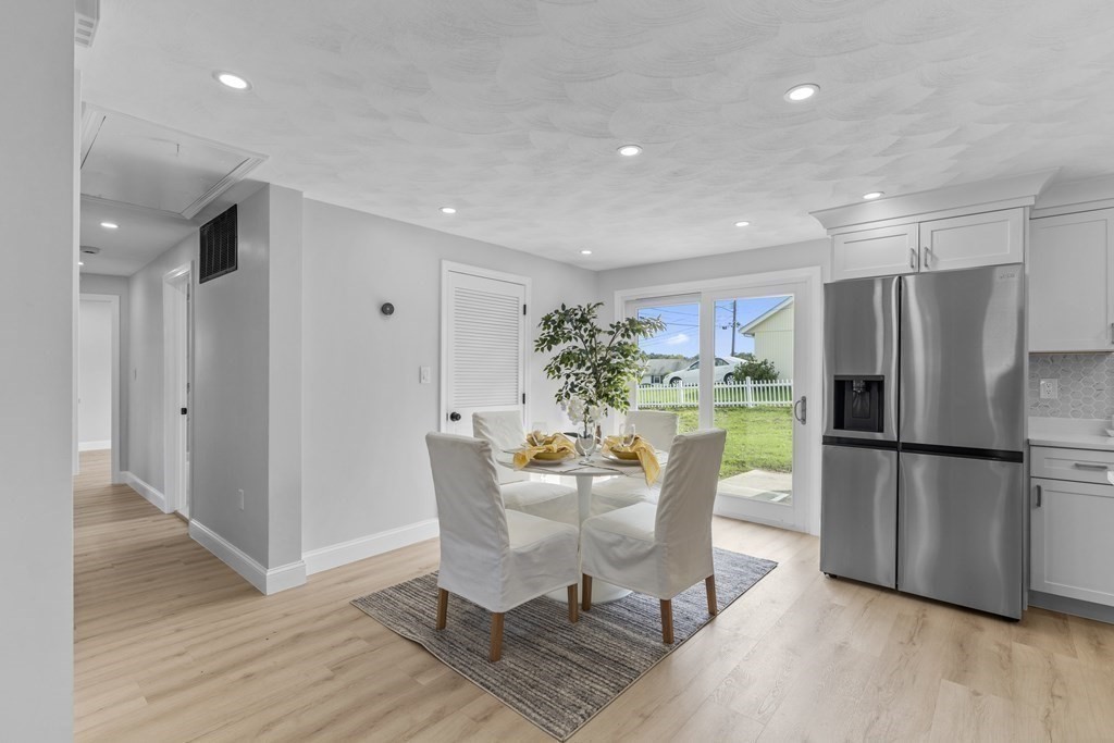 181 Green Street Stoneham, MA 02180 - Photo 9 of 42 a dining room with furniture and a refrigerator