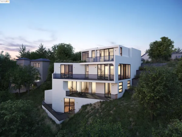 an aerial view of residential houses with outdoor space and trees