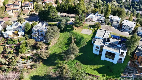 an aerial view of multiple houses with yard
