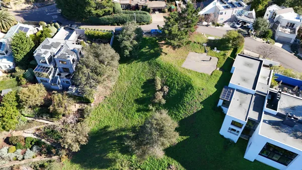 an aerial view of residential house with outdoor space and swimming pool