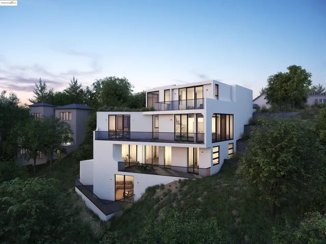 an aerial view of residential houses with outdoor space and trees