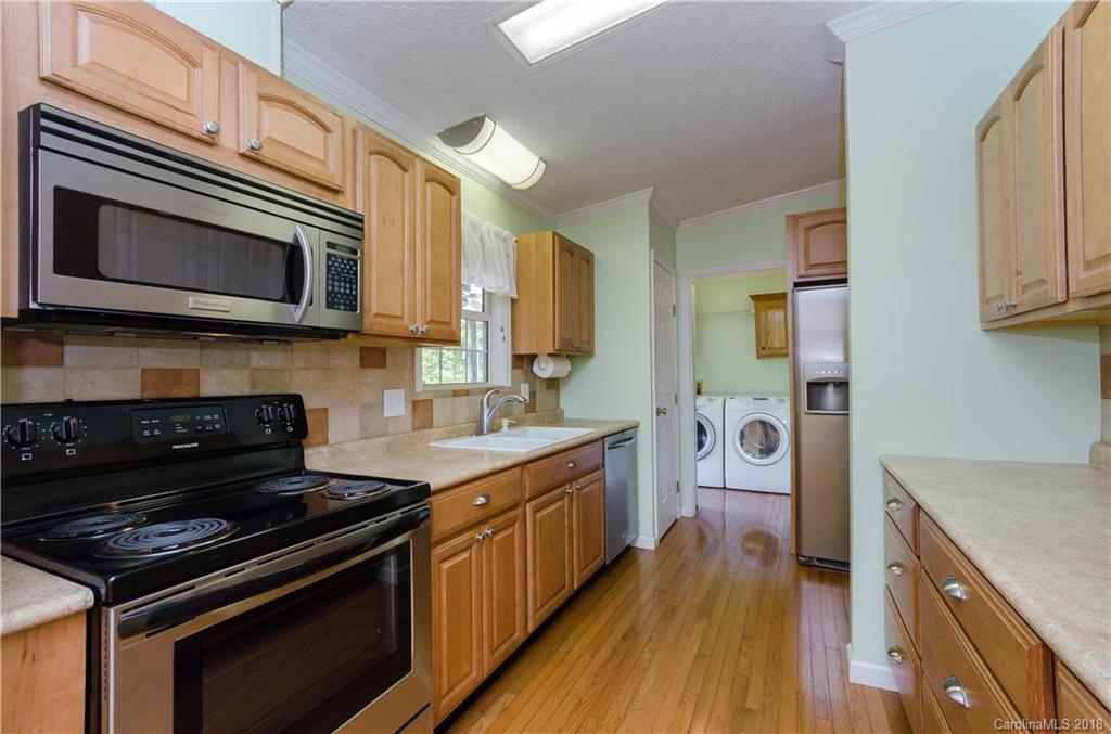 452 Souther Road Fletcher, NC 28732 - Photo 11 of 24 a kitchen with stainless steel appliances a stove microwave and cabinets