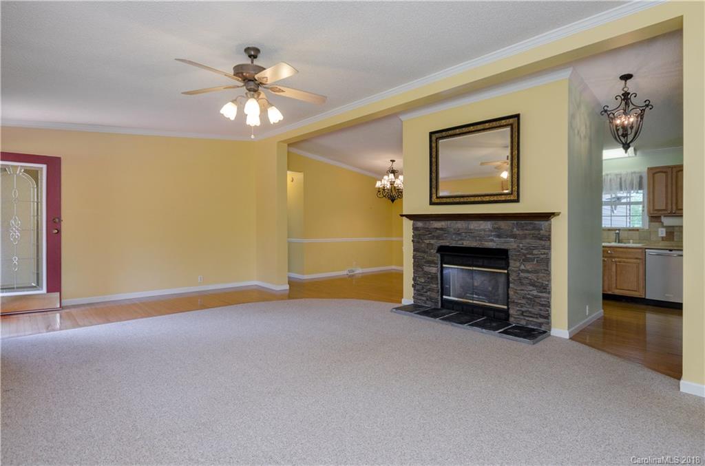 452 Souther Road Fletcher, NC 28732 - Photo 13 of 24 a view of a livingroom with a fireplace a chandelier fan and a fireplace