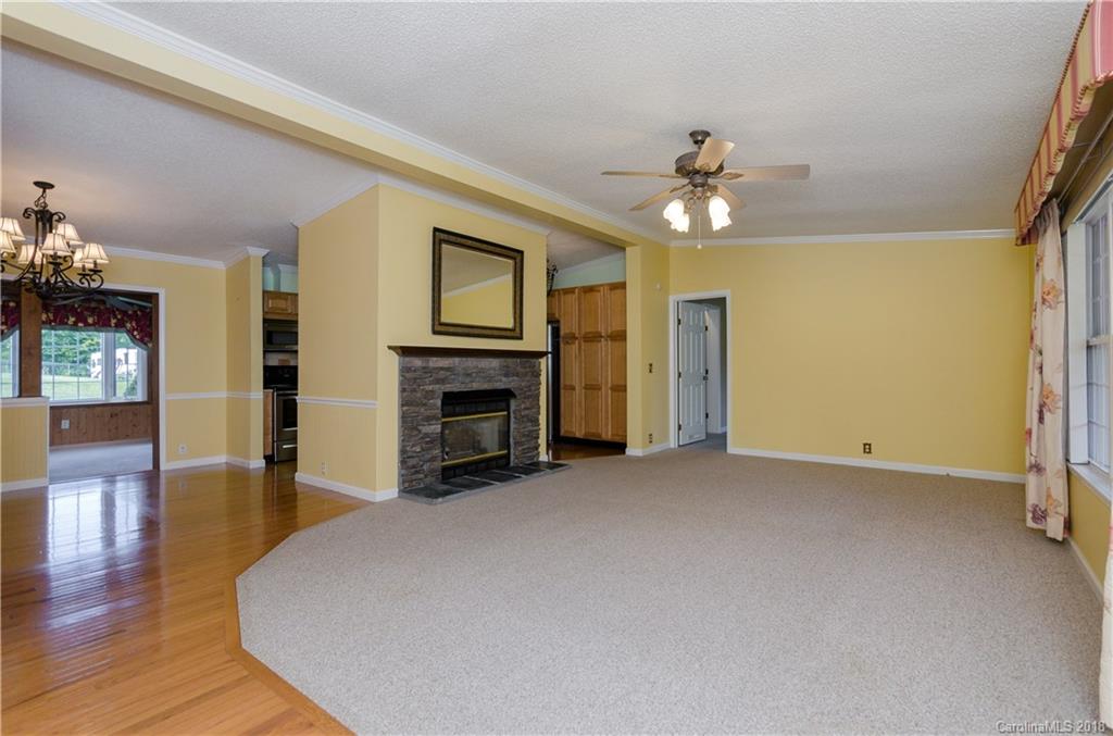 452 Souther Road Fletcher, NC 28732 - Photo 7 of 24 a view of empty room with wooden floor and fireplace