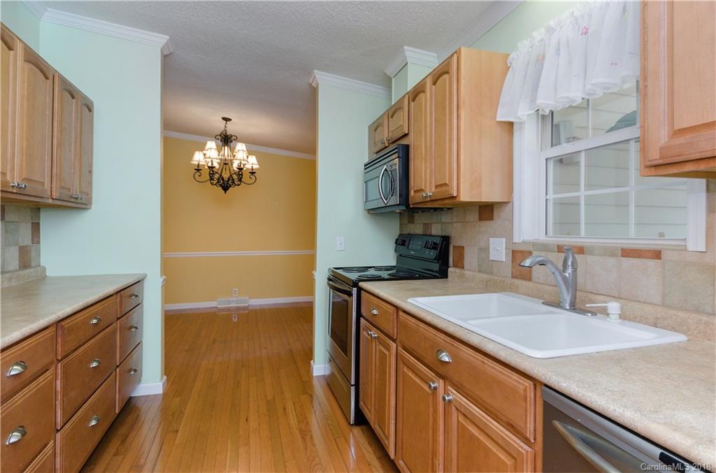 452 Souther Road Fletcher, NC 28732 - Photo 10 of 24 a kitchen with stainless steel appliances granite countertop a sink a stove and a wooden floors