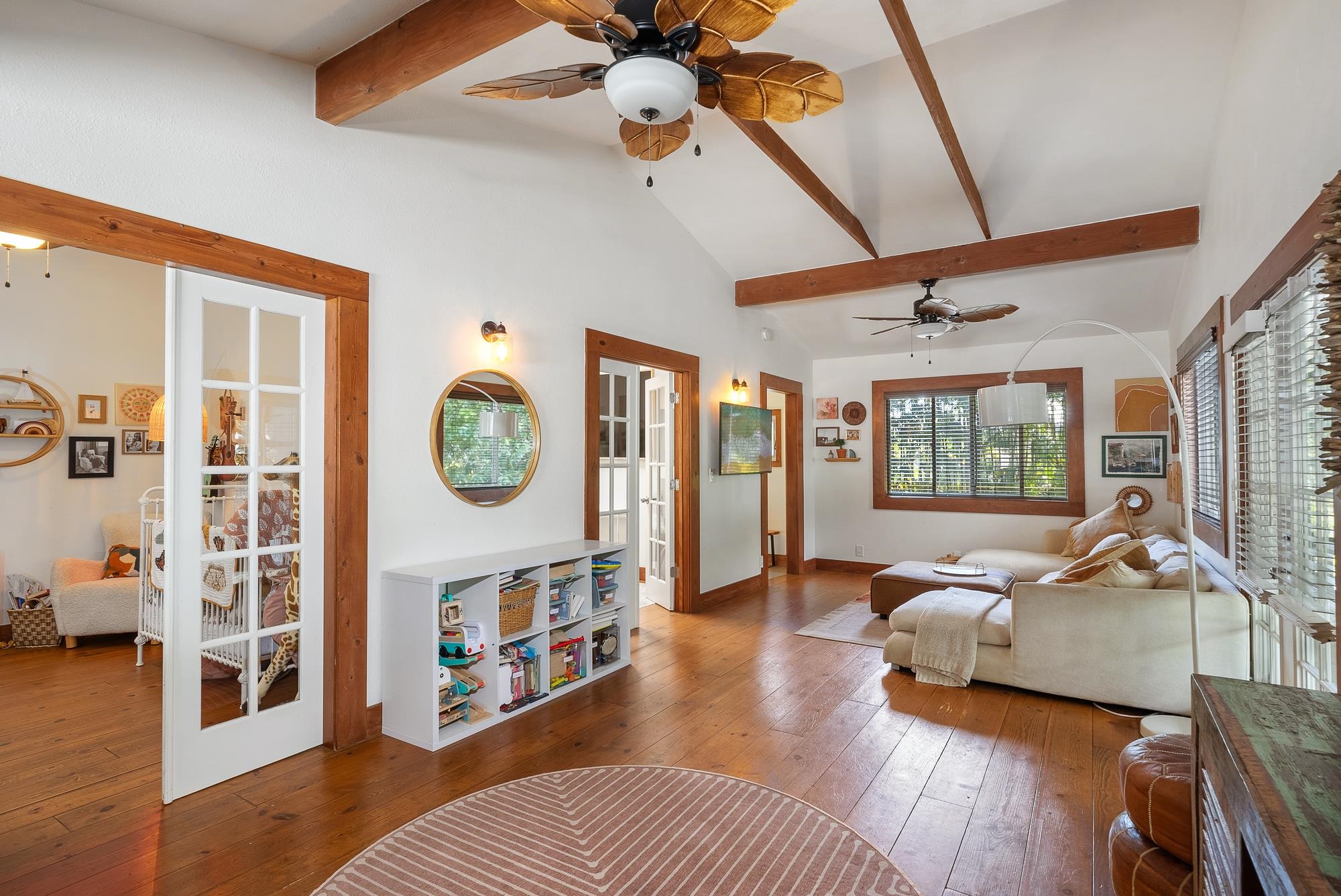 a living room with furniture and a wooden floor