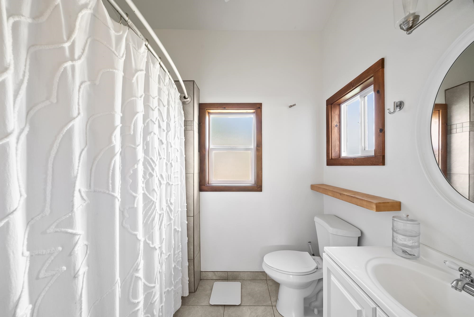 323 West Kuiaha Road Haiku, HI 96708 - Photo 26 of 30 a bathroom with a toilet sink and mirror