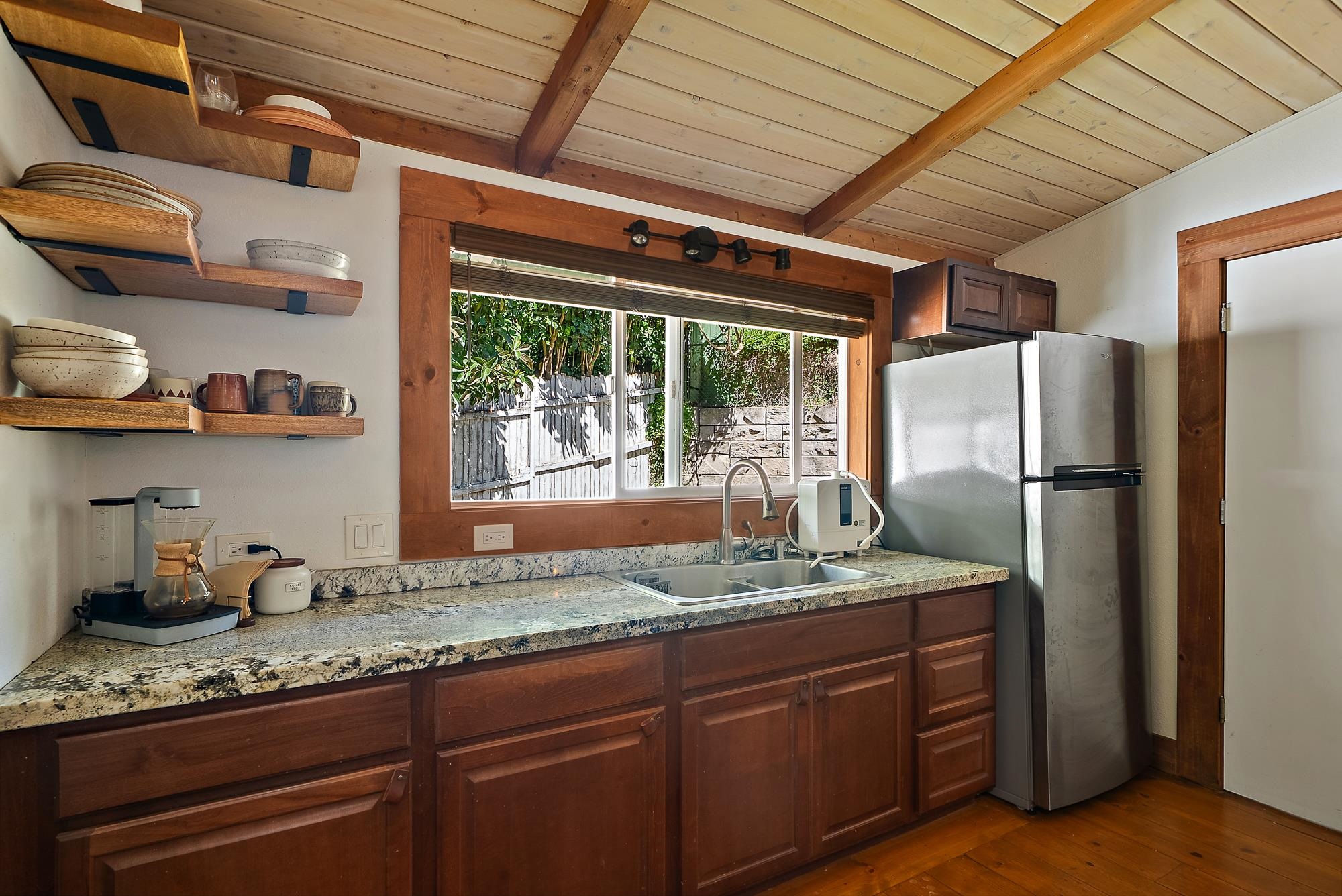 323 West Kuiaha Road Haiku, HI 96708 - Photo 7 of 30 a kitchen with granite countertop a sink stainless steel appliances and cabinets