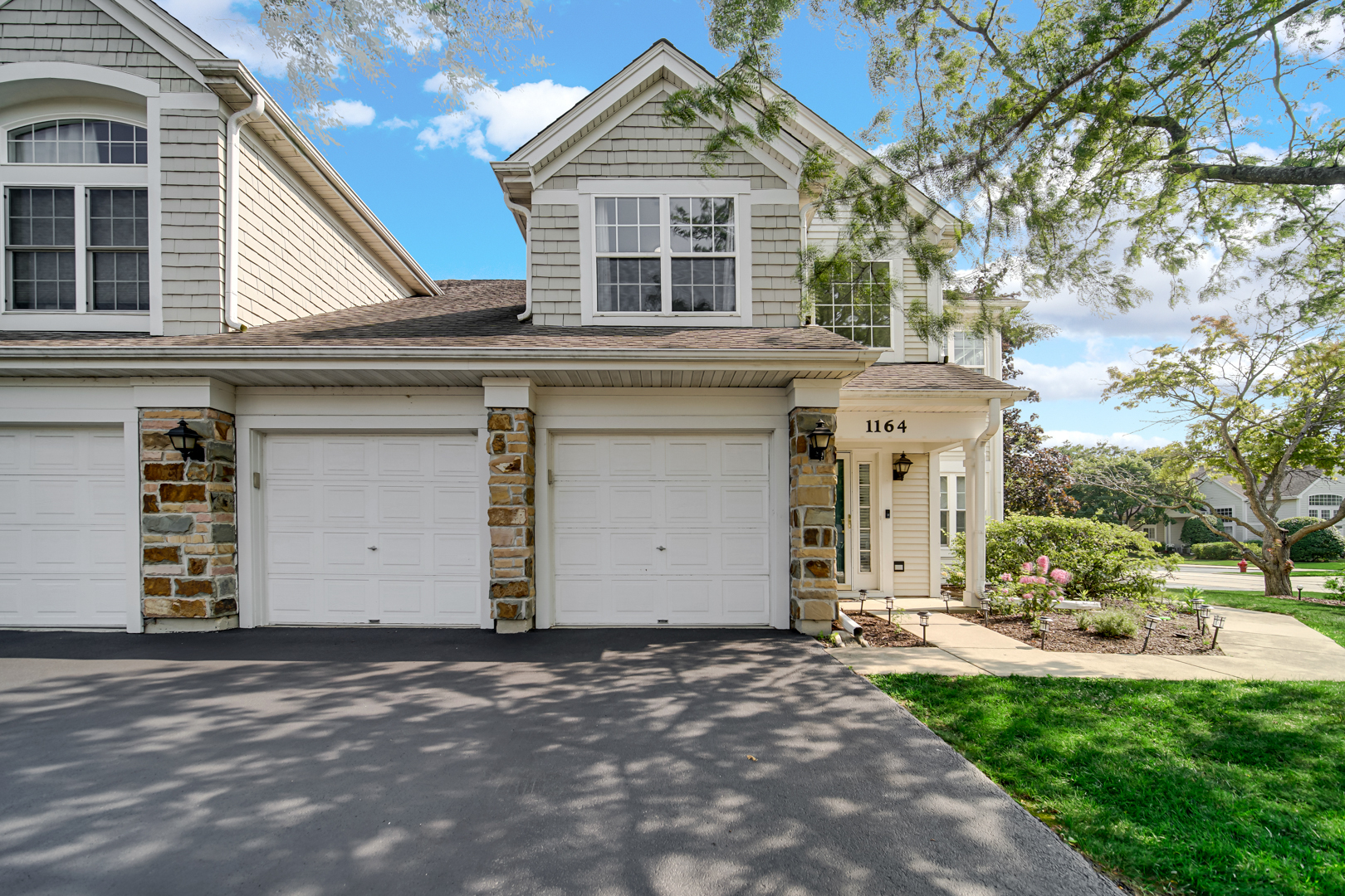 1164 Bristol Lane, Unit 1164 Buffalo Grove, IL 60089 - Photo 1 of 2 a front view of a house with a yard