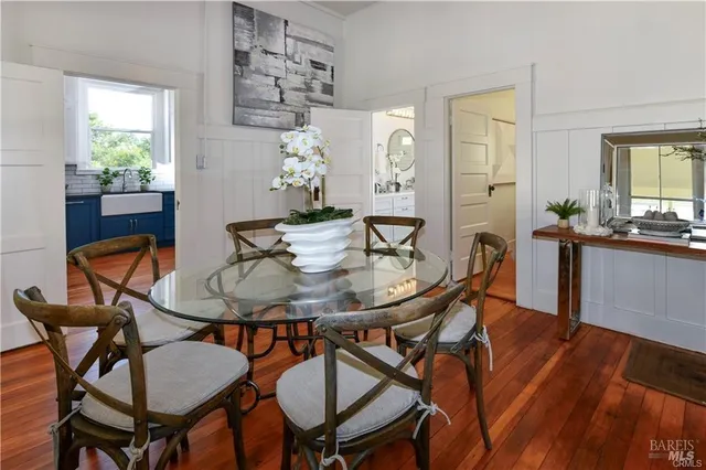 a view of a dining room with furniture and wooden floor
