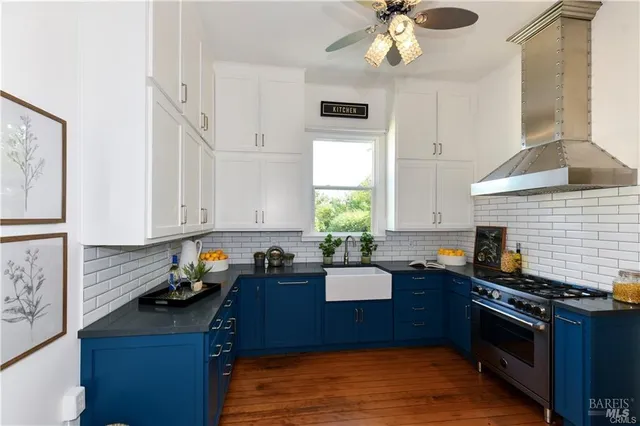 a kitchen with granite countertop a stove a sink and a cabinets