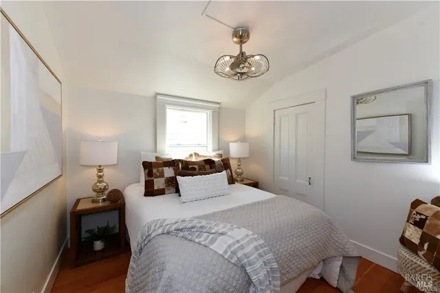 a bedroom with a bed and a chandelier