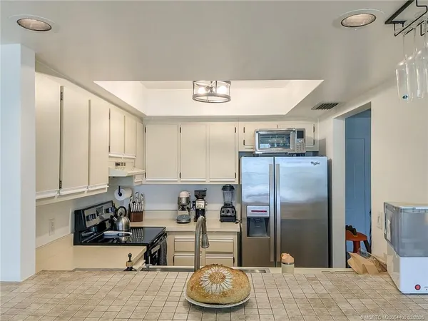 a kitchen with stainless steel appliances granite countertop a refrigerator and a stove
