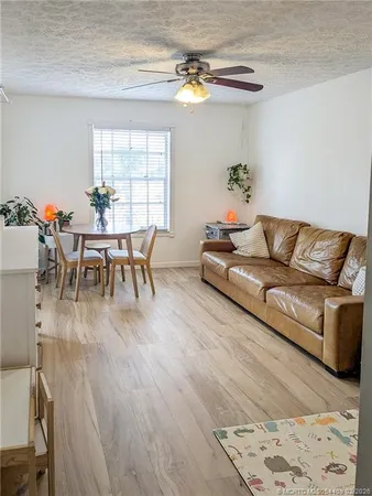 a living room with furniture dining table and a window