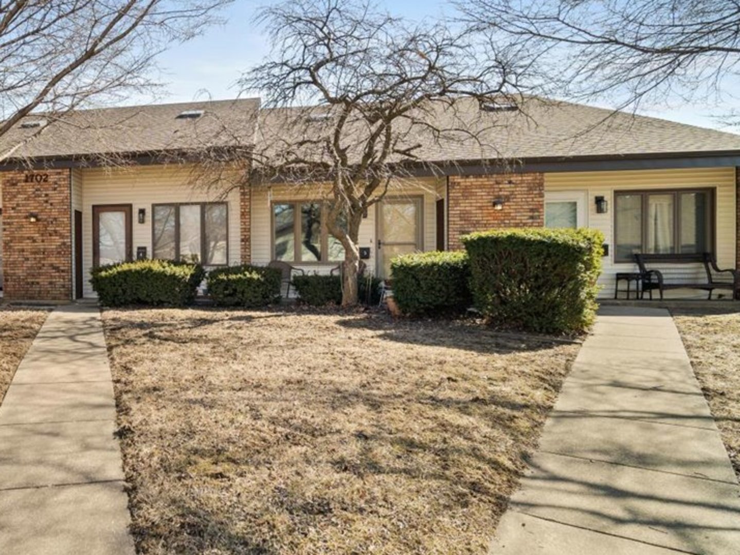 1702 Rockingham Drive, Unit 5 Normal, IL 61761 - Photo 1 of 17 a front view of a house with a yard