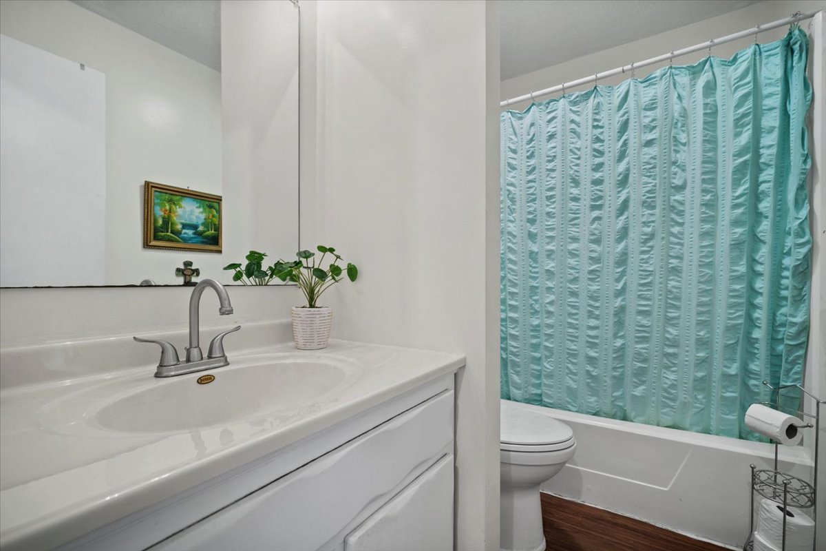 1702 Rockingham Drive, Unit 5 Normal, IL 61761 - Photo 11 of 17 a bathroom with a sink a toilet and a mirror