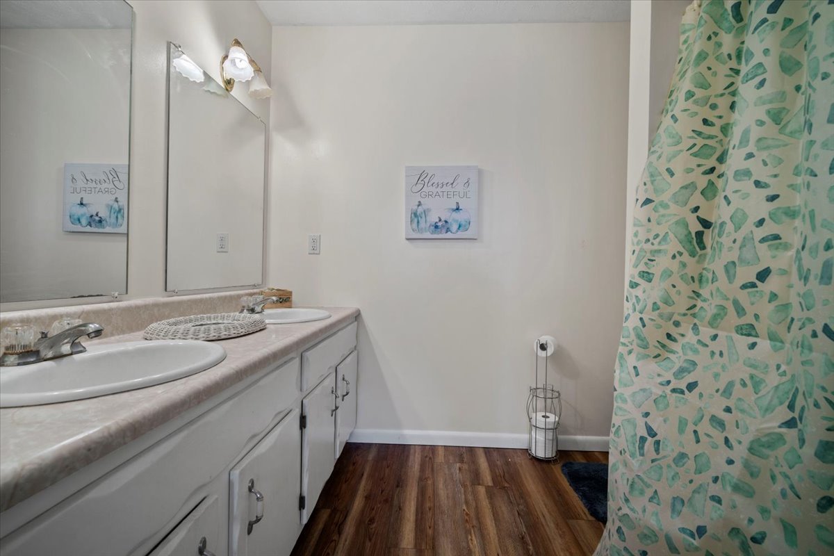 1702 Rockingham Drive, Unit 5 Normal, IL 61761 - Photo 12 of 17 a spacious bathroom with a sink a toilet a shower and a mirror