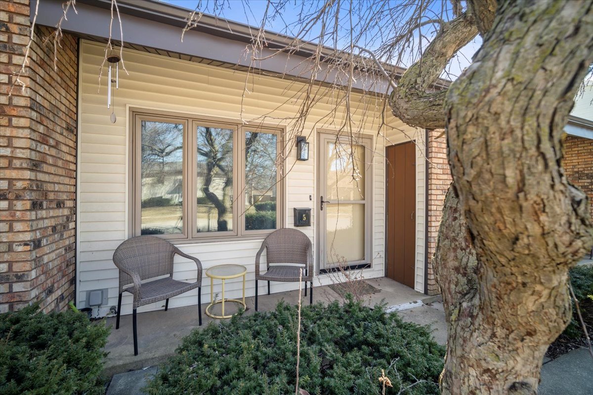 1702 Rockingham Drive, Unit 5 Normal, IL 61761 - Photo 3 of 17 a couple of chairs sitting in front of a glass door