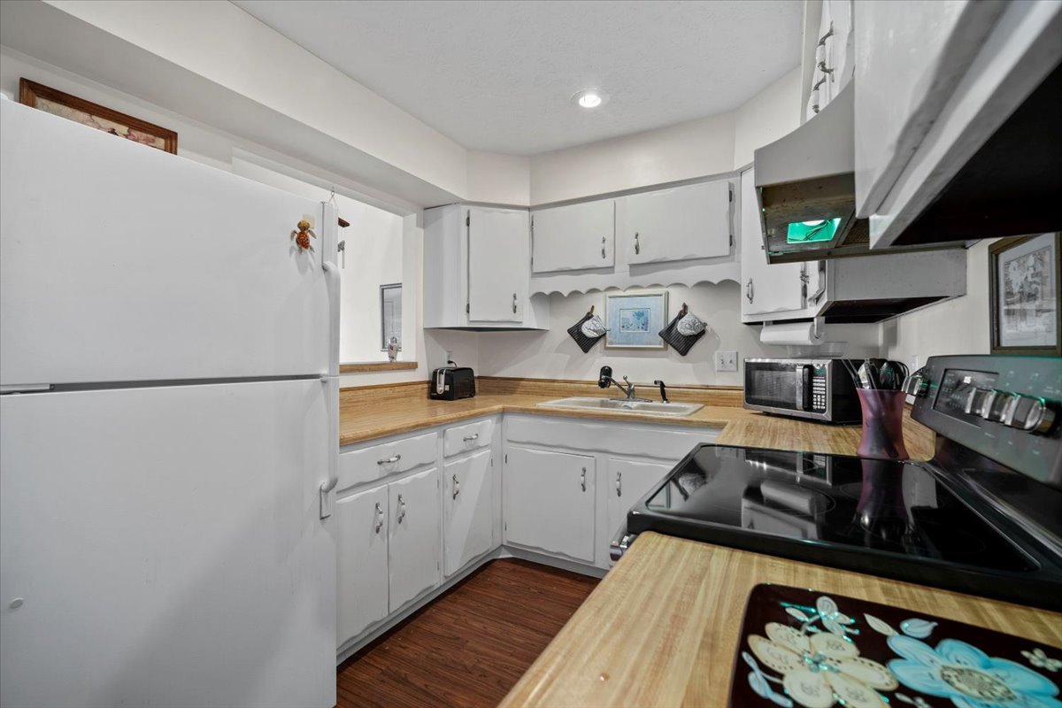 1702 Rockingham Drive, Unit 5 Normal, IL 61761 - Photo 7 of 17 a kitchen with stainless steel appliances granite countertop a refrigerator and a stove top oven