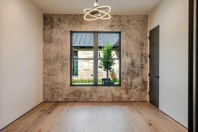 a view of a hallway with staircase and white walls