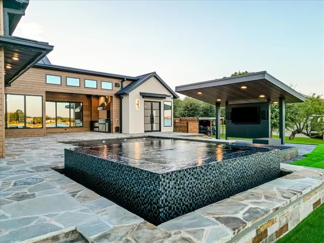 a view of a lake with boats in front of house