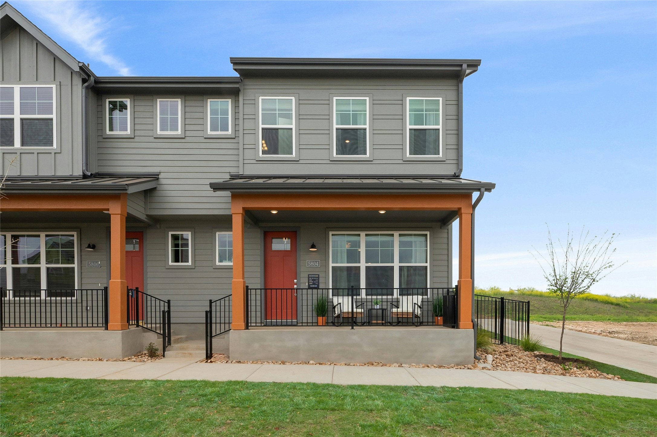 5804 Rotunda View Austin, TX 78747 - Photo 1 of 27 A welcoming front porch with a red entry door creates an inviting facade for this modern townhome.