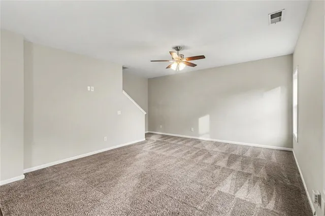 a view of an empty room with a fan