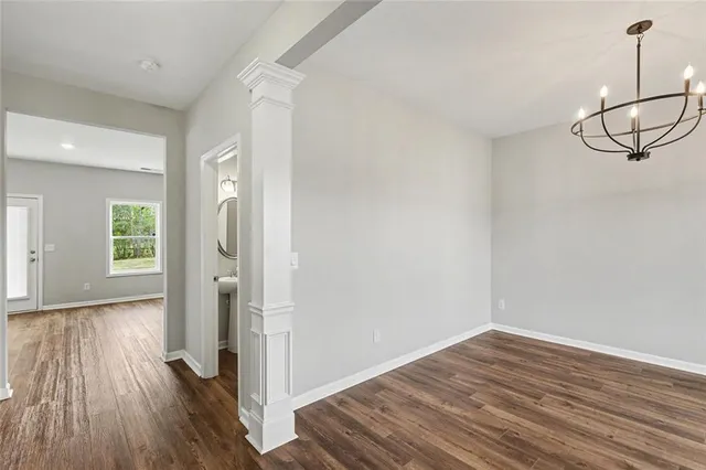 a view of a room with wooden floor and white walls