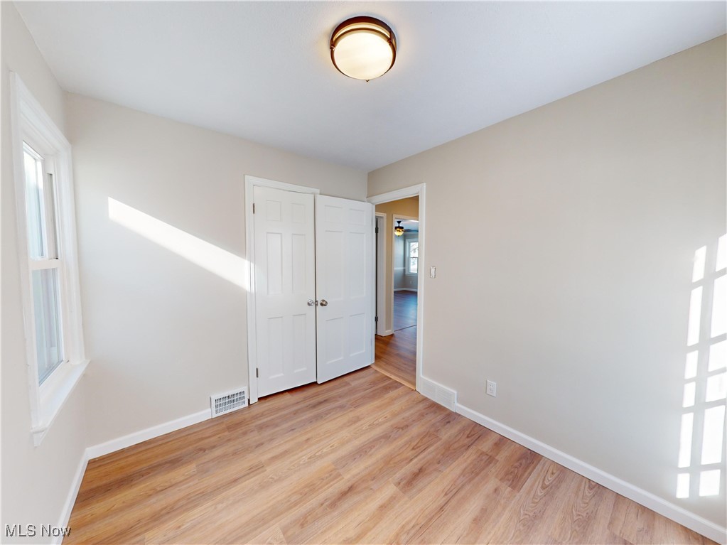 1343 Irene Road Lyndhurst, OH 44124 - Photo 15 of 32 Empty room with a healthy amount of sunlight and light wood-type flooring
