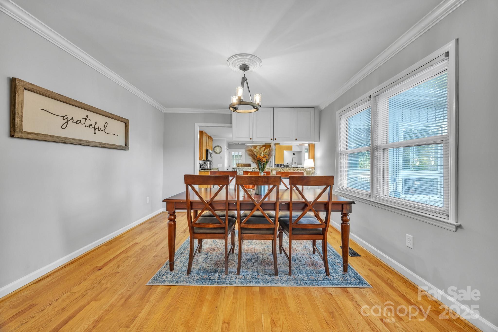 651 25th Avenue Northwest Hickory, NC 28601 - Photo 11 of 35 a dining room with furniture a chandelier and wooden floor