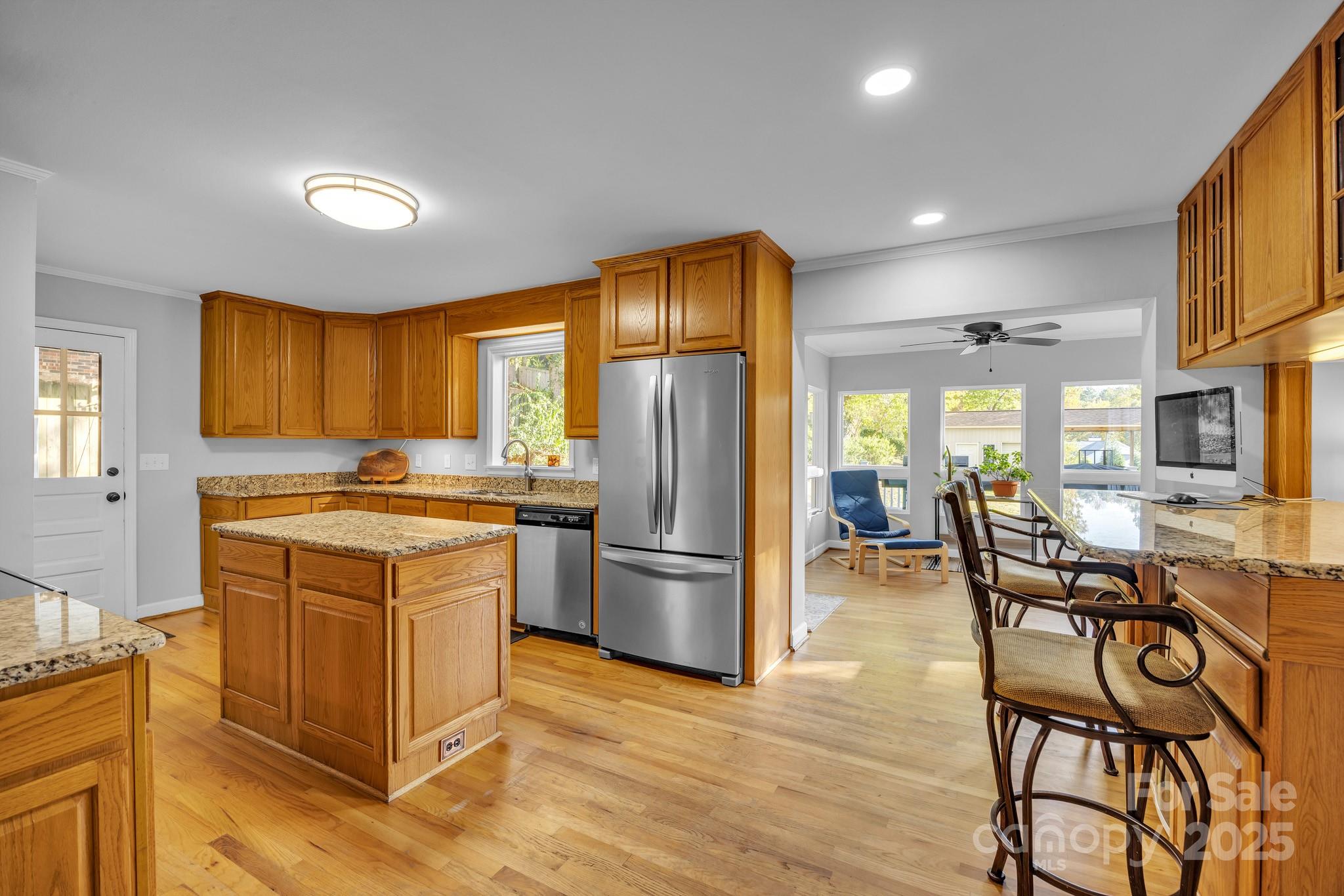 651 25th Avenue Northwest Hickory, NC 28601 - Photo 12 of 35 a kitchen with stainless steel appliances granite countertop a refrigerator a stove a sink a dining table and chairs with wooden floor