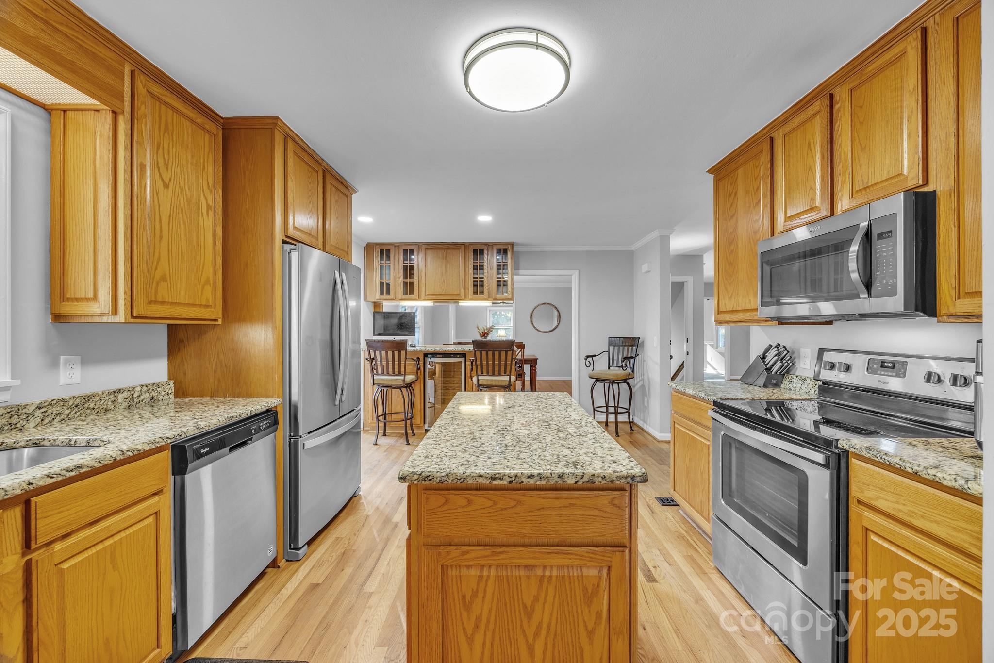 651 25th Avenue Northwest Hickory, NC 28601 - Photo 13 of 35 a kitchen with granite countertop stainless steel appliances and wooden cabinets