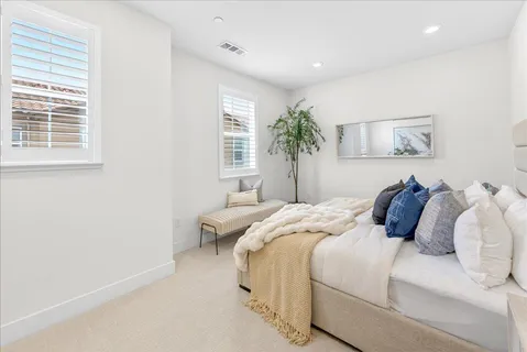 a bedroom with a bed and a painting on the wall