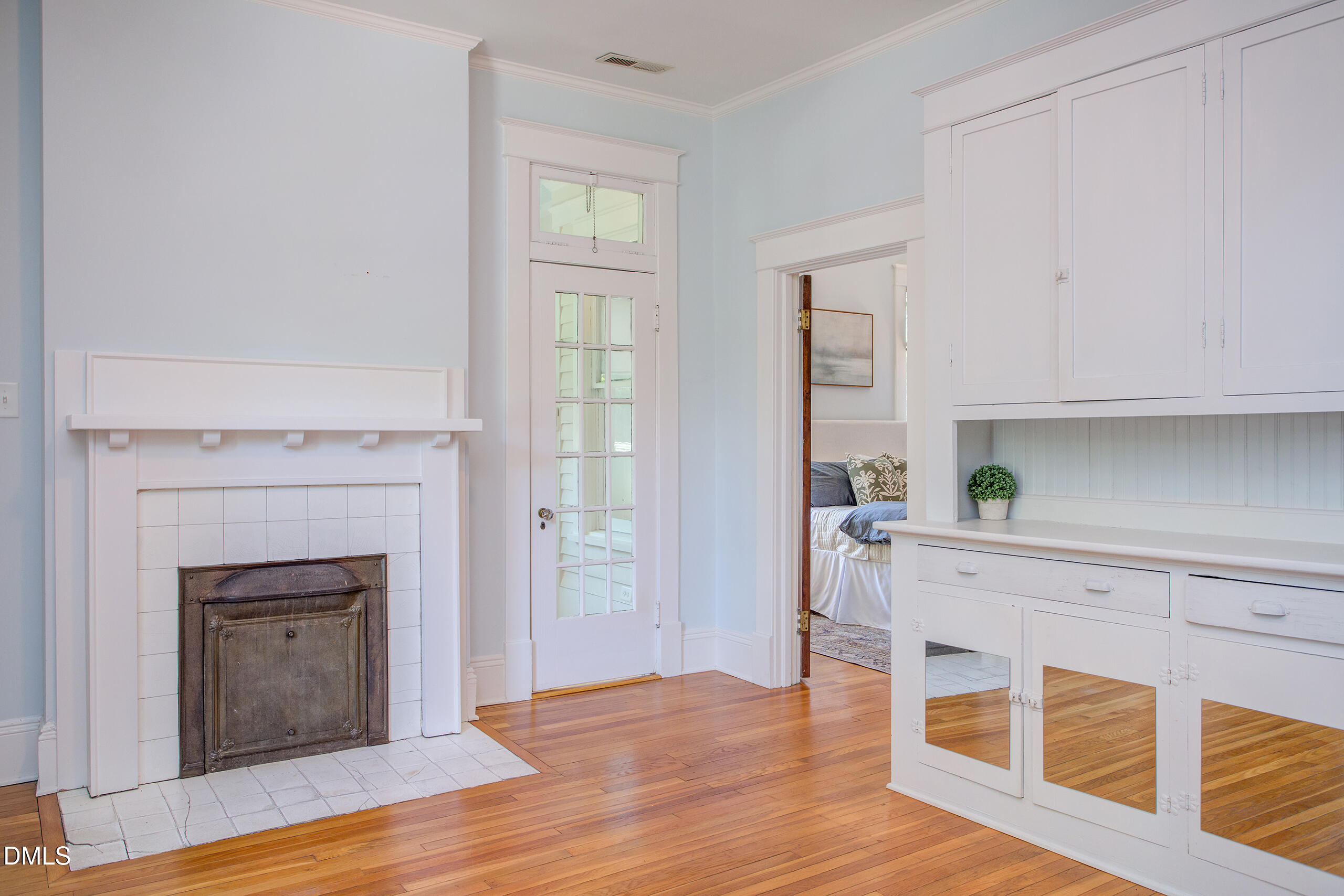 127 Forest Road Raleigh, NC 27605 - Photo 47 of 75 a living room with wooden floors and a fireplace