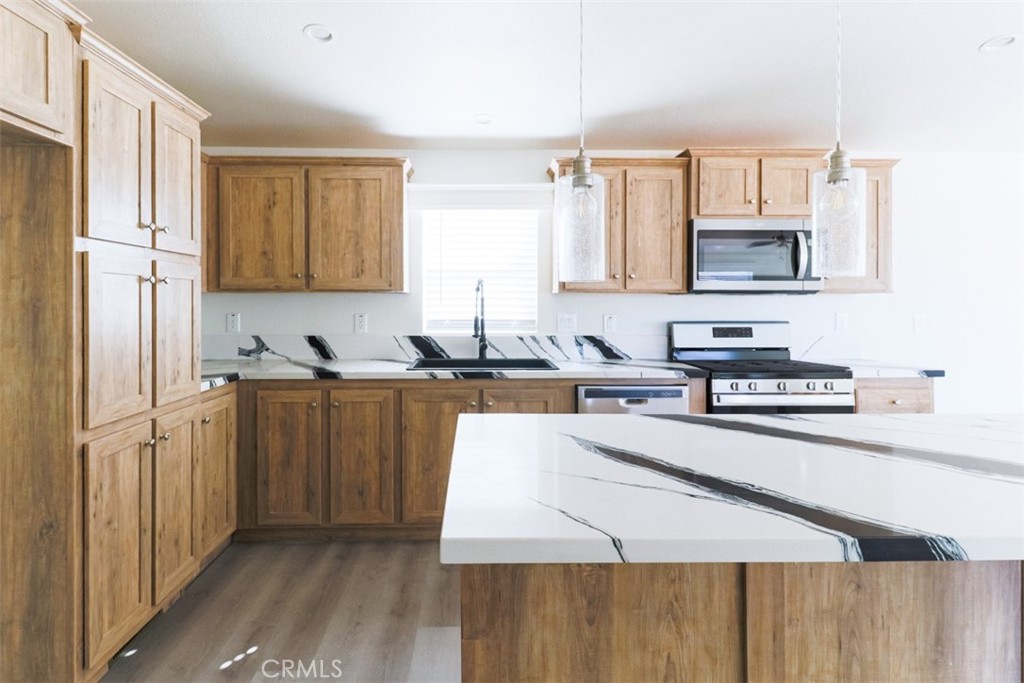40104 Walcott Lane Temecula, CA 92591 - Photo 14 of 41 a kitchen with stainless steel appliances granite countertop a stove a sink and a refrigerator