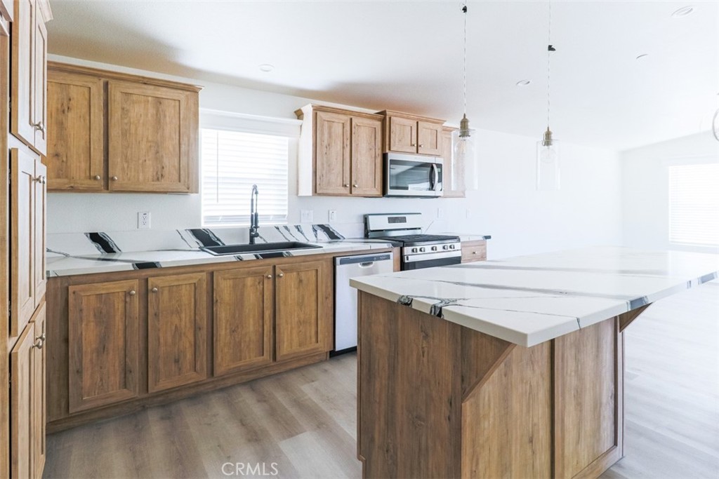 40104 Walcott Lane Temecula, CA 92591 - Photo 15 of 41 a kitchen with a sink stove and cabinets