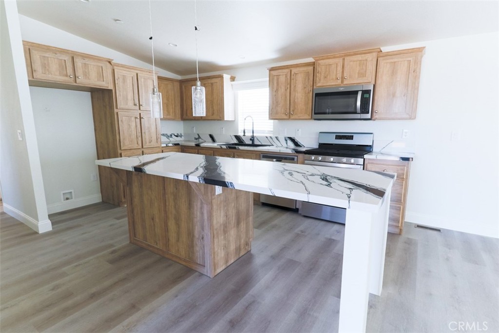 40104 Walcott Lane Temecula, CA 92591 - Photo 19 of 41 a kitchen with wooden cabinets and a sink