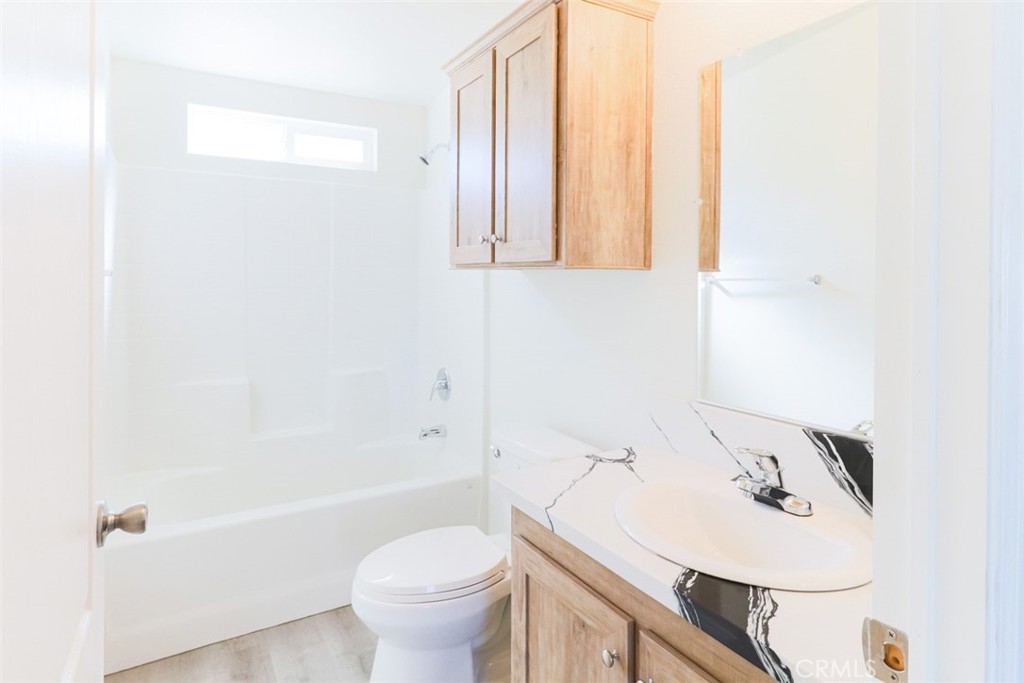 40104 Walcott Lane Temecula, CA 92591 - Photo 24 of 41 a bathroom with a sink a toilet and a bathtub