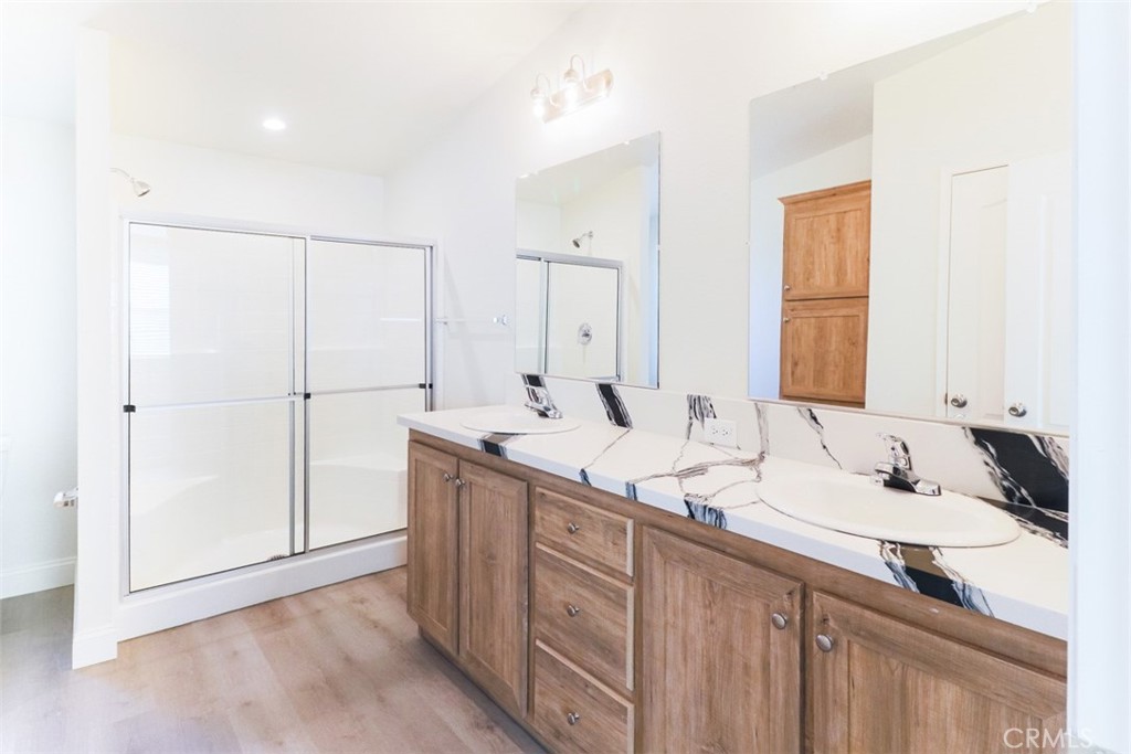 40104 Walcott Lane Temecula, CA 92591 - Photo 31 of 41 a bathroom with a double vanity sink and mirror
