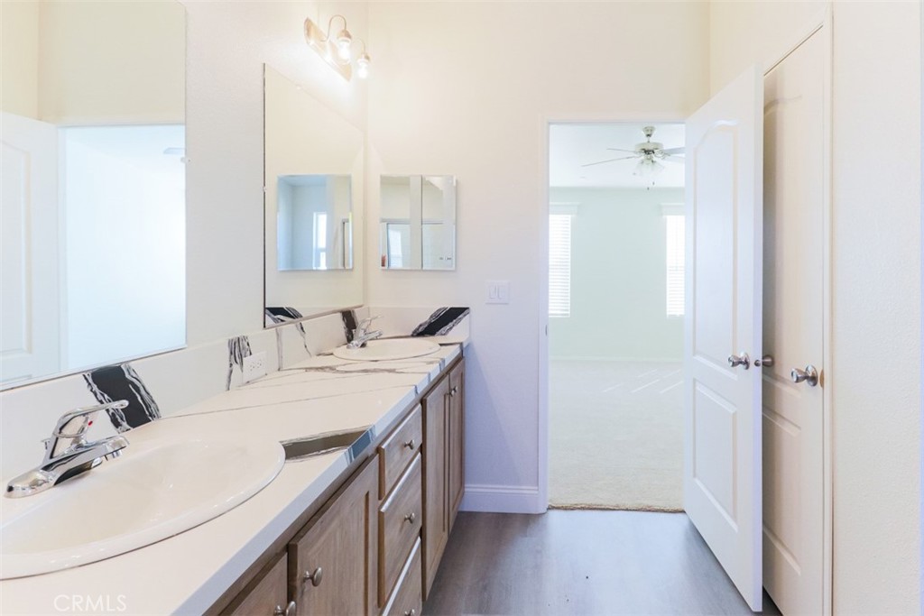 40104 Walcott Lane Temecula, CA 92591 - Photo 33 of 41 a en suite bathroom with a double vanity sink and a mirror