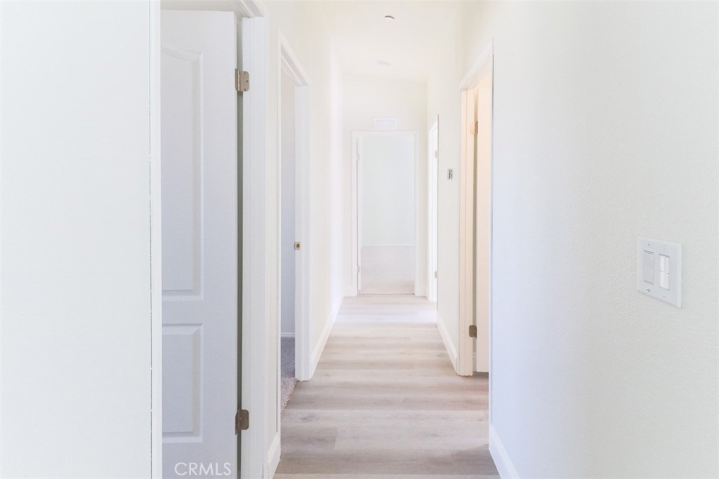 40104 Walcott Lane Temecula, CA 92591 - Photo 35 of 41 a view of a hallway with wooden floor