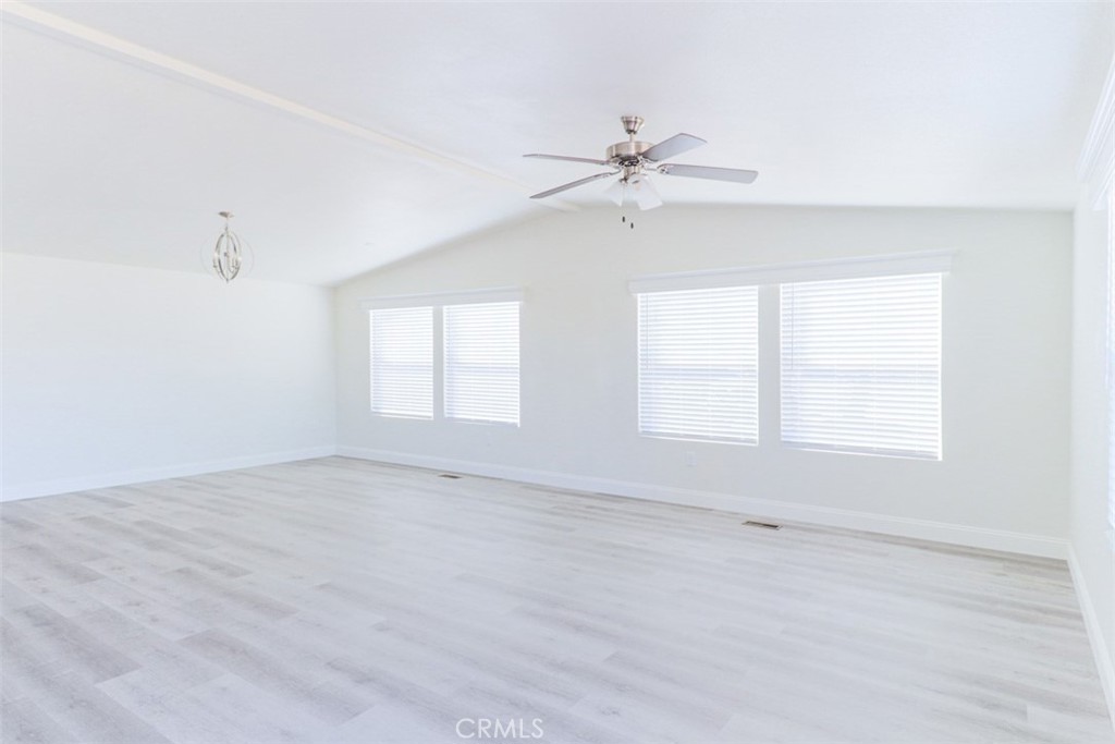 40104 Walcott Lane Temecula, CA 92591 - Photo 6 of 41 an empty room with a window and a ceiling fan