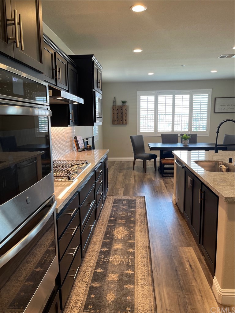 35334 Thorpe Trail Beaumont, CA 92223 - Photo 14 of 74 a kitchen with stainless steel appliances granite countertop a stove a sink and a microwave