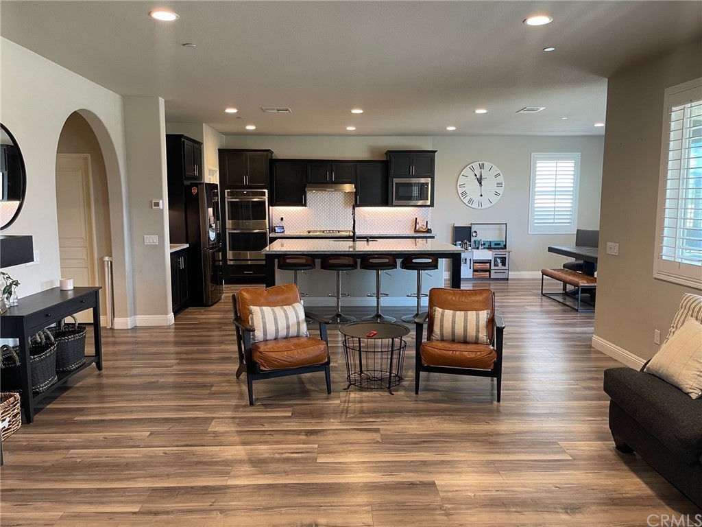 35334 Thorpe Trail Beaumont, CA 92223 - Photo 17 of 74 a living room with fireplace furniture and a wooden floor