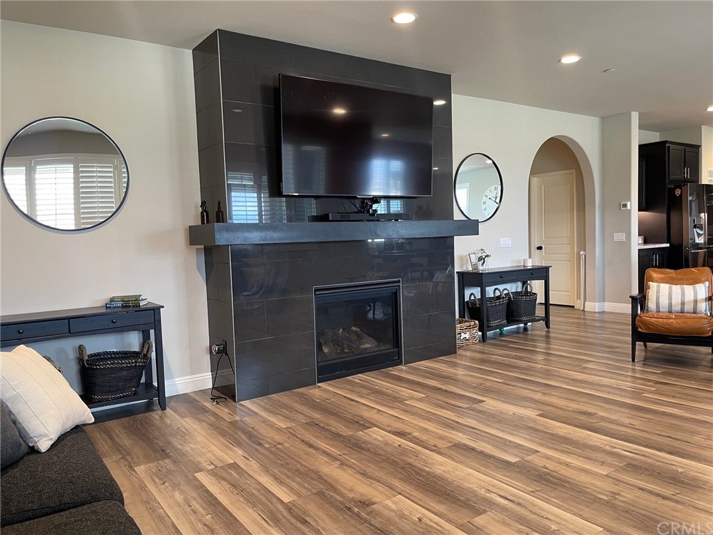 35334 Thorpe Trail Beaumont, CA 92223 - Photo 18 of 74 a living room with furniture a fireplace and a flat screen tv