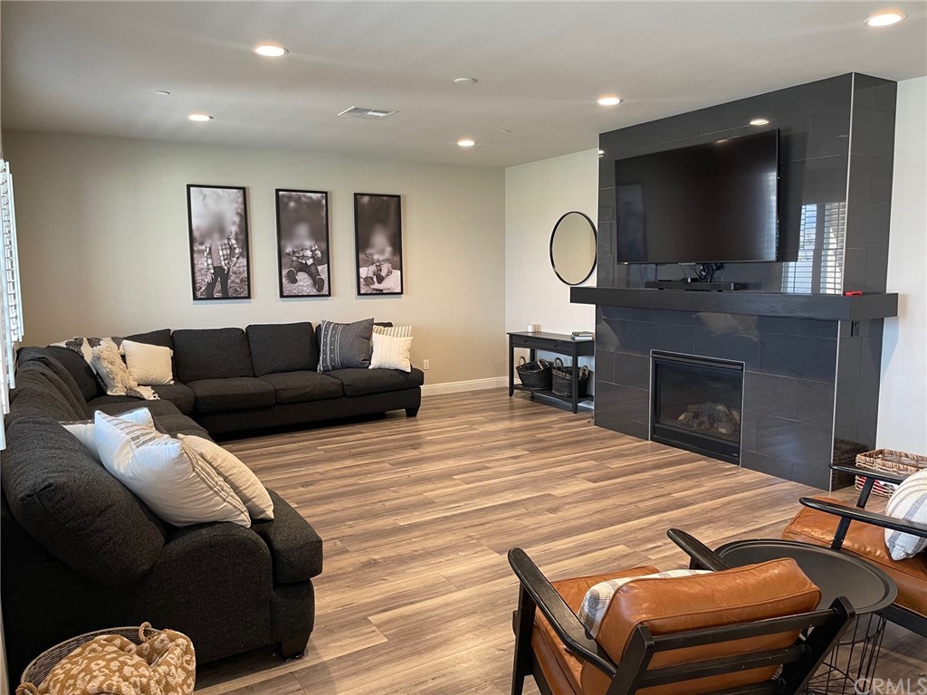 35334 Thorpe Trail Beaumont, CA 92223 - Photo 19 of 74 a living room with furniture a flat screen tv and a fireplace